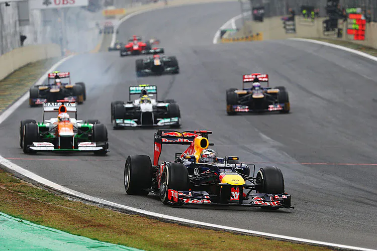 Sebastian Vettel of Red Bull Racing leads a train of cars through Turn One during the Formula One Brazilian Grand Prix, November 25, 2012. Vettel will be back with Red Bull, according to the official 2013 F1 roster. (Mark Thompson/Getty Images)
