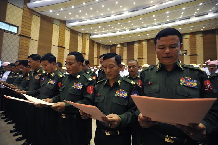 Newly appointed military representatives of the Burma Parliament take an oath during the third session of the upper house on April 23. (Soe Than Win/AFP/Getty Images)