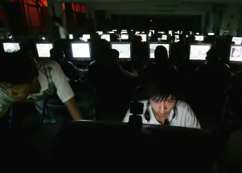 A young man in a cyber cafe in Wuhan, China, on June 11, 2005 sits at work at a computer. The Chinese regime encourages individuals known as patriot hackers to steal information from governments and companies. (Cancun Chu/Getty Images)