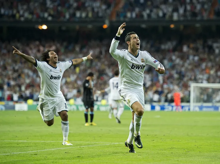 Real Madrid’s Cristiano Ronaldo (R) celebrates his game-winning goal against Manchester City in Champions League play in Madrid on Tuesday, September 18, 2012. (Jasper Juinen/Getty Images)