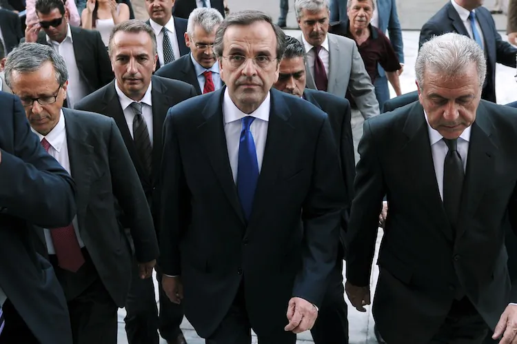 Greece's new Prime Minister Antonis Samaras and Foreign minister Dimitris Avramopoulos (R), flanked by security and newly appointed ministers, arrive at the Greek parliament for their first cabinet meeting on June 21. (Louisa Gouliamaki/AFP/GettyImages)