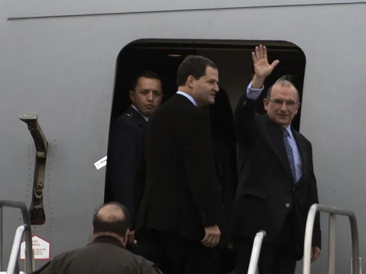 Colombia's government head of negotiators Humberto de la Calle (R) waves while boarding a plane in Bogota, Colombia, on Oct. 16. Peace talks will take place with leftist Revolutionary Armed Forces of Colombia (FARC) in Oslo, Norway starting Oct. 18. (Eitan Abramovich/AFP/Getty Images)