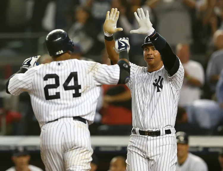 Robinson Cano (L) and Alex Rodriguez celebrate the rout Wednesday night. (Elsa/Getty Images)