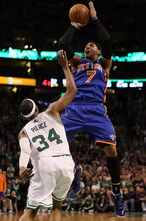 Carmelo Anthony (7) scored a team-high 25 points, while Boston's Paul Pierce (34) put up 34 in the Celtic's 115–111 win Sunday. (Elsa/Getty Images)