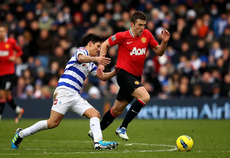 Michael Carrick of Manchester United goes past Alejandro Faurlin of QPR during the Barclays Premier League match between Queens Park Rangers and Manchester United at Loftus Road on December 18, 2011 in London, England. (Richard Heathcote/Getty Images)