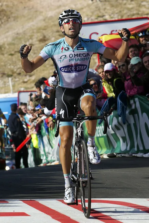 Dario Cataldo of Omega-Pharma Quickstep celebrates as he crosses the finish line to win the Stage Sixteen of the Vuelta a España. (Jaime Reina/AFP/GettyImages)