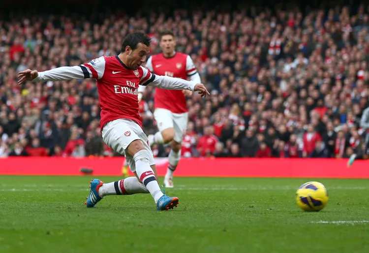 Tottenham Hotspur striker Emmanuel Adebayor (L) is shown a red card by referee Howard Webb in a match against Arsenal at Emirates Stadium on Nov. 17, 2012. (Clive Rose/Getty Images)