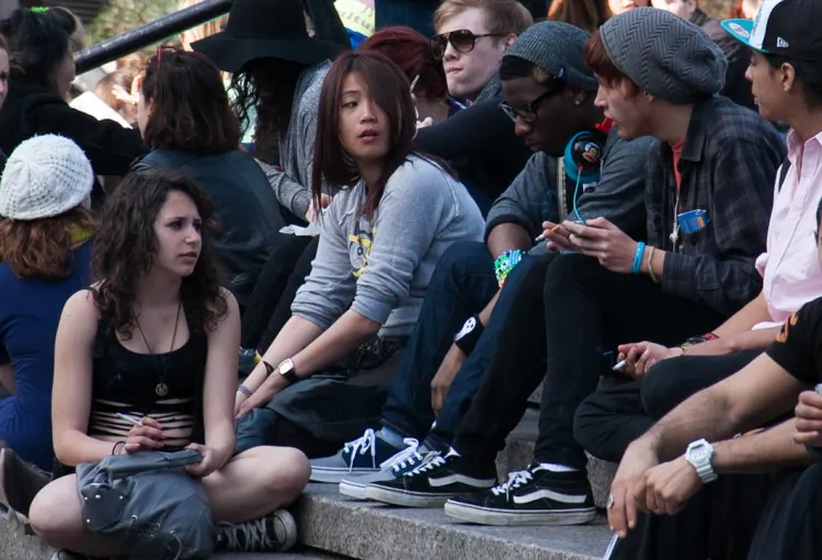 Teens smoking cigarettes on the steps in Union Square park in Manhattan on March 8. According to a report by the U.S. Surgeon General, one in three Americans between the ages of 18 and 26 now smoke. (Benjamin Chasteen/The Epoch Times)