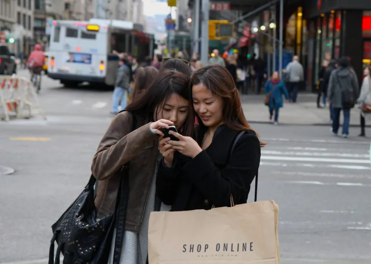 A woman checks her smart phone in New York City on Nov. 16. (Amal Chen/The Epoch Times)
