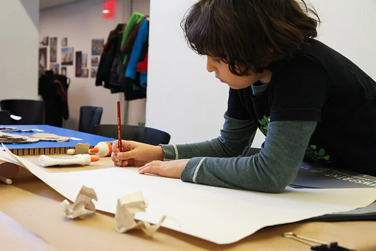 Zubin (Grade four) helps his brother Avi (Grade three) add a bridge on the island they created together. . (Benjamin Chasteen/The Epoch Times)