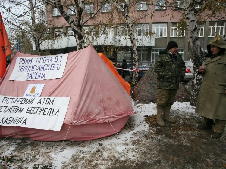 Men who helped clean up after the Chernobyl nuclear plant disaster in 1986 stand near a tent during a protest against deep cuts to their pensions Nov. 16 in the eastern industrial city of Donetsk, Ukraine. A court on Wednesday banned the veterans from continuing their hunger strike to protest the cuts. (Alexander Khudoteply/AFP/Getty Images)