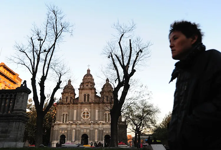 A man walks past the state-sanctioned St. Joseph's Catholic Cathedral on Wangfujing in Beijing. There are two Catholics churches in China: the officially sanctioned, Communist Party-controlled one, and an unofficial 'clandestine' Church that is loyal to the pope and the Vatican. (Frederic J. Brown/AFP/Getty Images)