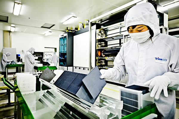 A masked worker sorts silicon wafers at the manufacturing centre of solar cell maker Trina Solar in Changzhou, China, in November, 2009. (PHILIPPE LOPEZ/AFP/GETTY IMAGES)