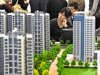 Chinese house shoppers gather at a property fair in Beijing on August 2, 2010. (AFP/Getty Images)