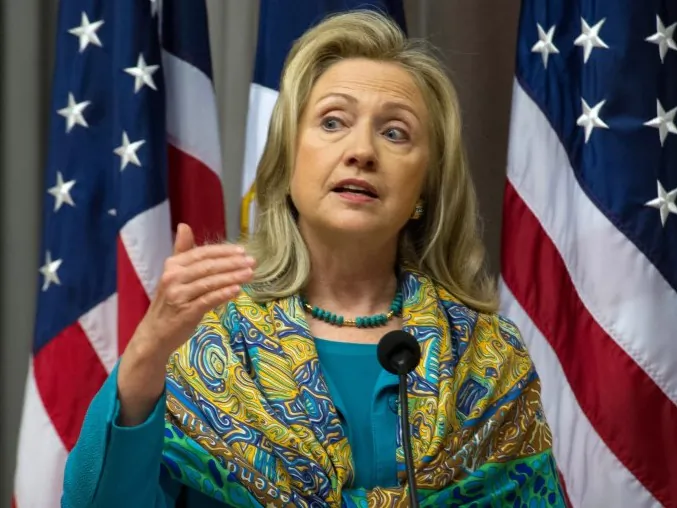 Dressed in aqua for World Water Day, U.S. Secretary of State Hillary Rodham Clinton remarks on a recent intelligence report linking several national security threats to water problems. (Karen Bleier/AFP/Getty Images)