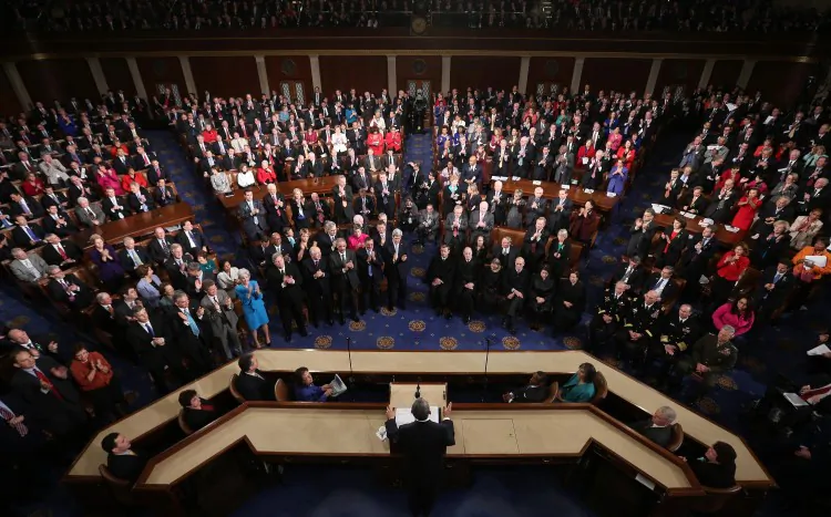 Former U.S. Representative Gabrielle Giffords and her husband, former astronaut Mark Kelly, listen to U.S. President Barack Obama deliver his State of the Union address before a joint session of Congress. (Mandel Ngan/AFP/Getty Images)