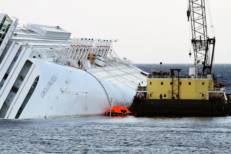 Salvage workers start the work of recovering fuel from the cruise ship Costa Concordia that lies stricken off the shore of the Italian island of Giglio on Jan. 24, in Giglio Porto, Italy. The diesel recovery operation starts Wednesday, while the rescue operation will continue. (Laura Lezza/Getty Images)