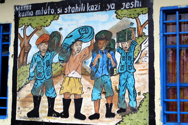 A picture deploring the recruitment of child soldiers painted by former child soldiersmanaged by UNICEF-partner CAJED in Goma, DRC, in August. Amid recent clashes between M23 rebels and the national Congolese army, about 200,000 children in Goma are currently at risk of being recruited. (UNICEF DRC/Cornelia Walther)