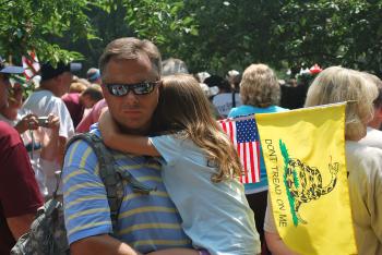 Man and child rally to 'Restore Honor' at the Washington Monument. (Ronny Dory/The Epoch Times)
