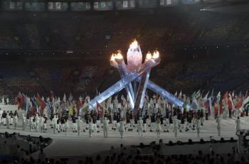 Athletes walk around the Olympic cauldron during the Closing Ceremony. (Mathew Little/The Epoch Times) Athletes walk around the Olympic cauldron during the Closing Ceremony. (Mathew Little/The Epoch Times)