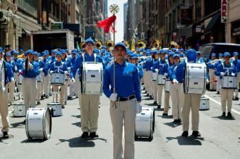 The Divine Land Marching Band, composed mostly of Falun Gong practitioners, warms up before a parade in Manhattan on June 6. (Joshua Philipp/The Epoch Times)
