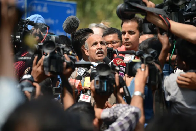 Indian attorney V.K. Anand, representing Ram Singh, the main accused of a fatal gang-rape case and who was found dead in his prison cell March 11, 2013, talks to journalists outside the Deen Diyal Upadhyay hospital mortuary in New Delhi, India. (Sajjad Hussain/AFP/Getty Images)
