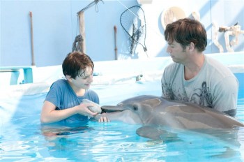 (L-R) Nathan Gamble, and Harry Connick Jr. aiding the injured dolphin Winter, in the true story 'Dolphin Tale.' (Jon Farmer/Warner Bros. Pictures) (L-R) Nathan Gamble, and Harry Connick Jr. aiding the injured dolphin Winter, in the true story 'Dolphin Tale.' (Jon Farmer/Warner Bros. Pictures)