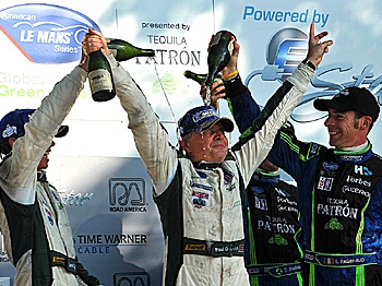Lord Paul Drayson (C) is showered in victory lane by co-driver Jonny Cocker (L) and competitor Simon Pagenaud (R) of France, after co-driving the #8 Drayson Racing Lola to victory at the American Le Mans Series Road America race. (Rick Dole/Getty Images)