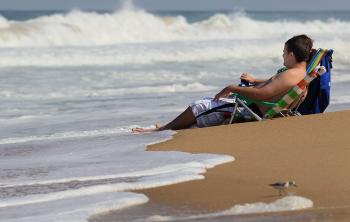 People in beach chairs watch the high surf caused by Hurricane Earl on Sept. 1 in Kitty Hawk, N.C. (Mark Wilson/Getty Images)