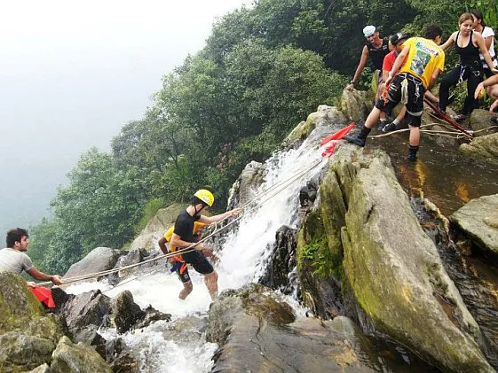 Tourists are guided to pass the Smokey Falls in Serra do Mar, near Paranapiacaba, in the state of São Paulo, on Dec. 4, 2012. (Jan Hendriks Junior/Adventure Challenge - Adventure Tourism)