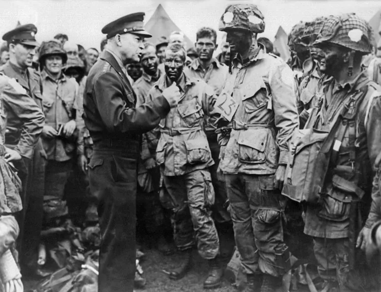 Picture of supreme commander for the 1944 cross-channel invasion of the continental mainland, general Dwight D. Eisenhower giving order of the day to the paratroopers, just before they board their airplane to participate in the first assault in the invasion of the continent of Europe, 06 June 1944, England. (AFP/GettyImages)