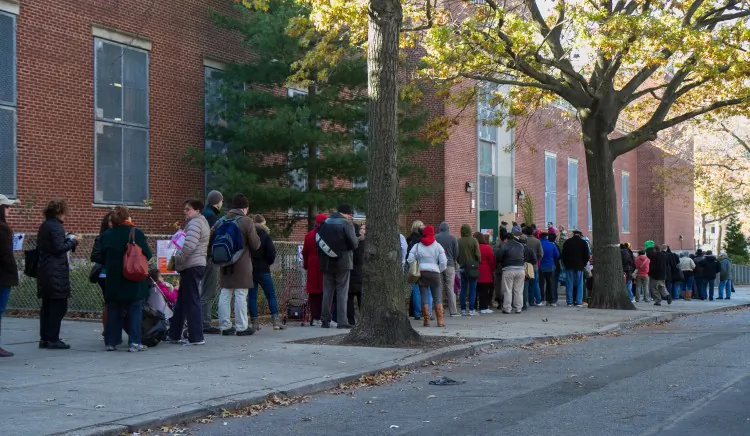 People line up waiting to vote for the presidential election at the MS 51 middle school in Brooklyn, New York City, on Nov. 6. Many people complained that it took longer than 2 hours to vote. (Benjamin Chasteen/The Epoch Times)