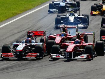 Jenson Button (L) pushes down the inside past Fernando Alonso (R) while Felipe Massa (C) follows into the first chicane at the start of the Formula 1 Italian Grand Prix at the Autodromo Nazionale di Monza. (Paul Gilham/Getty Images) Jenson Button (L) pushes down the inside past Fernando Alonso (R) while Felipe Massa (C) follows into the first chicane at the start of the Formula 1 Italian Grand Prix at the Autodromo Nazionale di Monza. (Paul Gilham/Getty Images)
