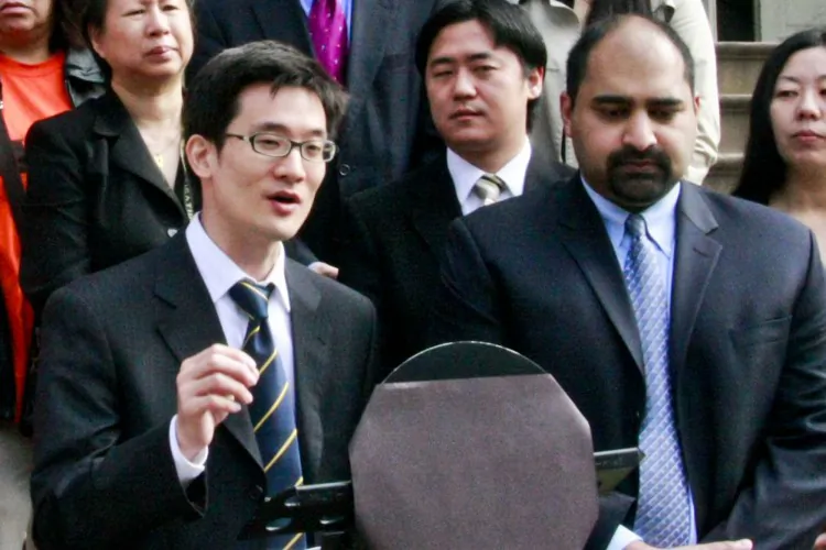 James Hong (L) of the Asian American Community Coalition on Redistricting and Democracy, and Jerry Vattamala (R), staff attorney for Asian America Legal Defense and Education Fund stand with minority organizations to call on the City Council and mayor-appointed redistricting committee to keep together groups of interest in redistricting from the steps of City Hall on Tuesday. (Aric Chen/The Epoch Times)