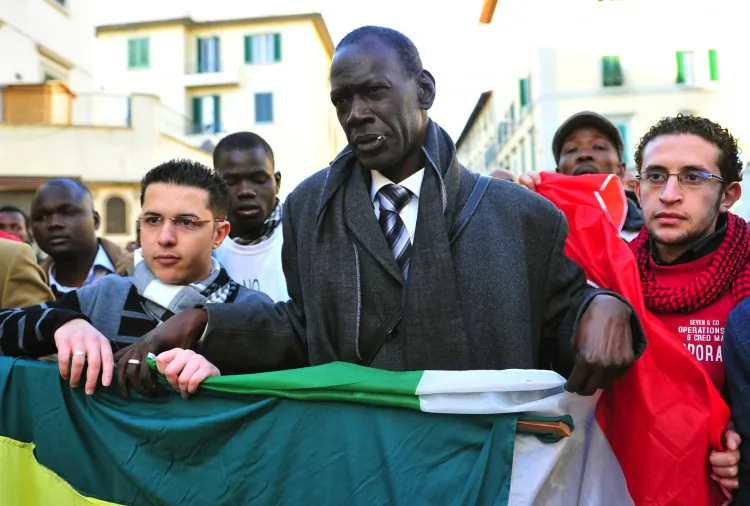 Spokesman for the Senegalese community of Florence, Pape Diaw (C), takes part in an antiracist march in Florence on Dec. 17 attended by about 12,000 people, four times the number organizers expected. (AlbertoL PizzoliI/AFP/Getty Images)