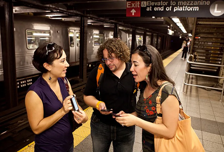 Kirsten Mickelson (R) of San Francisco, Ben Abo (C) of New Jersey, and Amy Coren of Washington D.C. try out the new underground wireless service when it was announced on September 26, 2011. (Amal Chen/The Epoch Times)