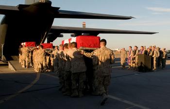 Pallbearers carry the caskets of slain Canadian journalist Michelle Lang and four fallen Canadian soldiers into a military aircraft on Jan. 1, 2010, to return them to Canada. (Sgt. Gemma Bibby of the Royal Air Force, DND) Pallbearers carry the caskets of slain Canadian journalist Michelle Lang and four fallen Canadian soldiers into a military aircraft on Jan. 1, 2010, to return them to Canada. (Sgt. Gemma Bibby of the Royal Air Force, DND)