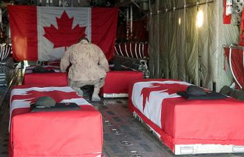 A Canadian soldier bids farewell in a military transport aircraft on Jan. 1, 2010, before his four fallen comrades and journalist Michelle Lang are flown back to Canada. (Sgt. Gemma Bibby of the Royal Air Force, DND) A Canadian soldier bids farewell in a military transport aircraft on Jan. 1, 2010, before his four fallen comrades and journalist Michelle Lang are flown back to Canada. (Sgt. Gemma Bibby of the Royal Air Force, DND)