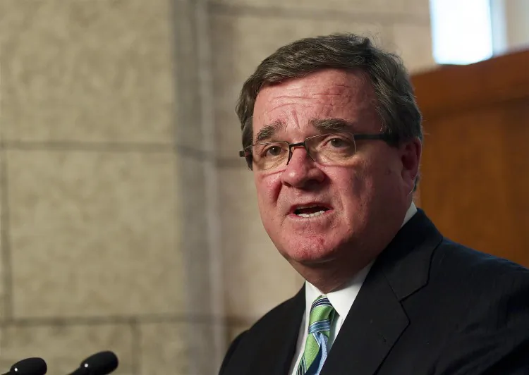 Finance Minister Jim Flaherty speaks with reporters on Wednesday. Flaherty welcomed the OECD’s praise for how Canada has weathered the economic downturn. (Matthew Little/The Epoch Times)