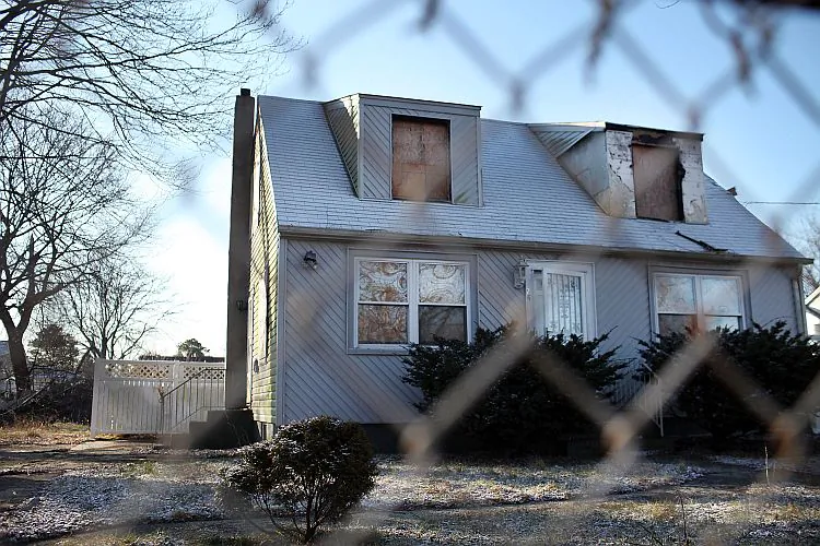 A foreclosed home stands boarded up on Feb. 9 in Islip, NY. A report released by RealtyTrac shows a slight increase in foreclosure-related filings for the month of January. (Spencer Platt/Getty Images)
