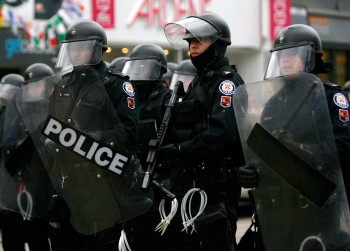 Toronto police officers take up positions as they face off with protesters at the corner of Queen Street and Spadina Avenue on June 27, 2010, in Toronto during the G20 summit. The Toronto Police Accountability Coalition says that police should conduct les (Jemal Countess/Getty Images)