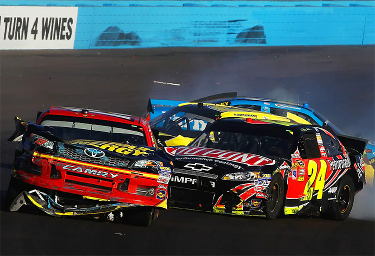 Jeff Gordon in the No. 24 DuPont Chevrolet spins Clint Bowyer in the No. 15 5-hour Energy Toyota, while behind them slide the wrecked cars of Joey Logano and Aric Amirola during the NASCAR Sprint Cup AdvoCare 500 at Phoenix International Raceway on November 11. (Tom Pennington/Getty Images for NASCAR)