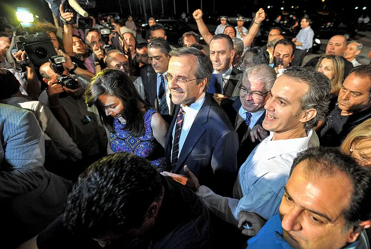 Greece's New Democracy party leader, Antonis Samaras (C), arrives for a press conference at the Zappion Hall in central Athens on June 17, after official projections declared his party the winner in Sunday's election. (Andreas Solaro/AFP/GettyImages