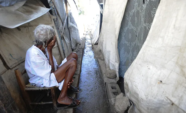 A Haitian woman sits in a tent city near Port-au-Prince on Jan. 10. Amnesty International said Thursday, on the two-year anniversary of the devastating earthquake, that thousands of Haitians living in camps have been forcefully evicted. (Thony Belizaire /AFP/Getty Images)