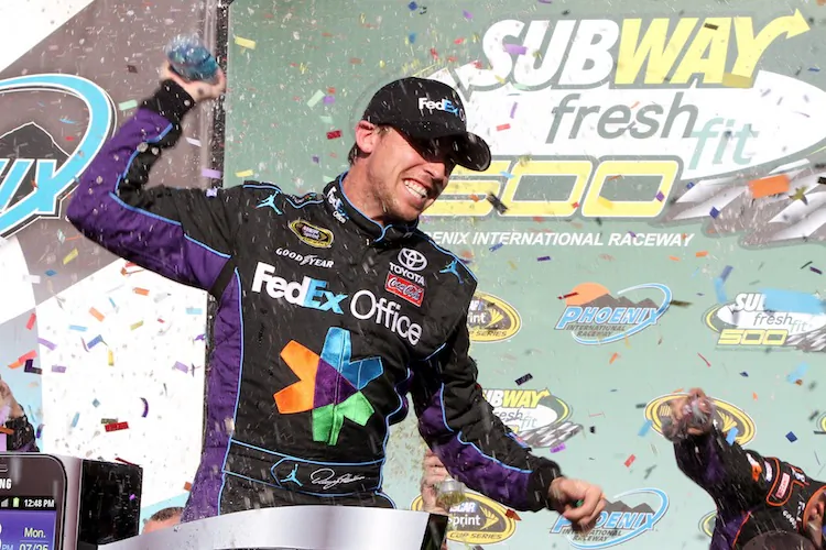 Denny Hamlin, driver of the 11 FedEx Office Toyota, celebrates after winning the NASCAR Sprint Cup Series Subway Fresh Fit 500 at Phoenix International Raceway. (Jerry Markland/Getty Images for NASCAR)