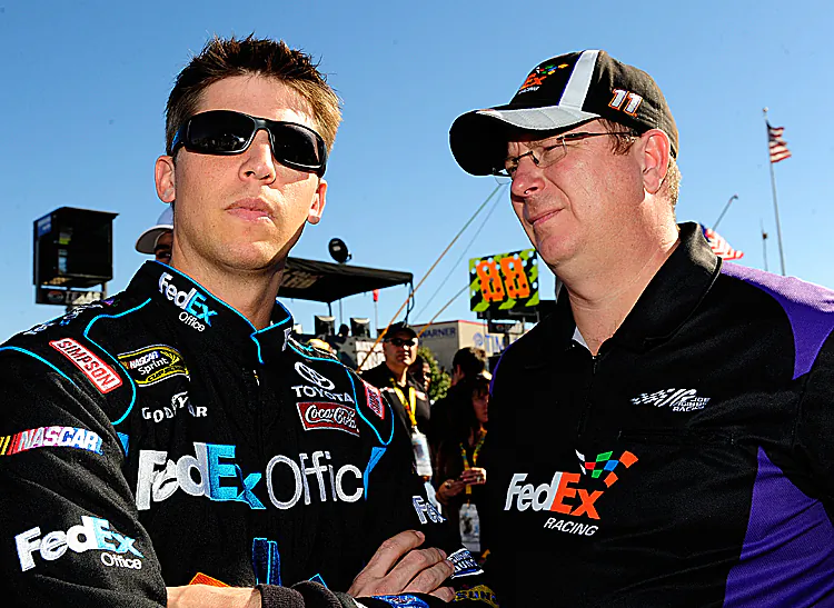 Denny Hamlin and crew chief Mike Ford stand on the grid prior to the NASCAR Sprint Cup AAA Texas 500 on Nov. 7, 2010. (Rusty Jarrett/Getty Images for NASCAR)