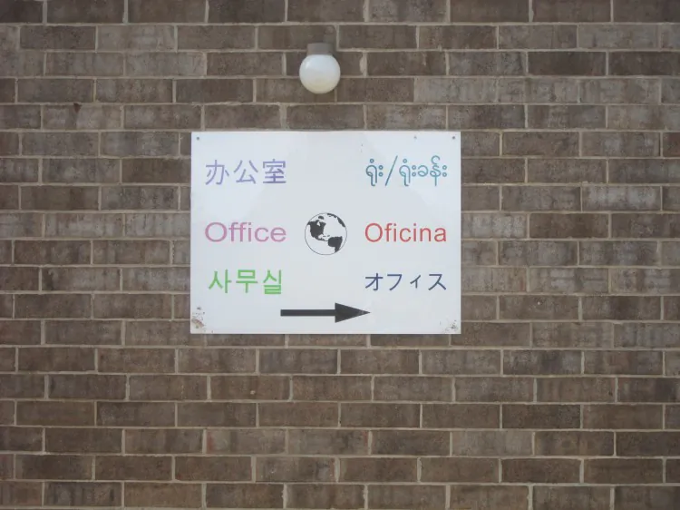 An elementary school sign in many languages shows people how to get to the office. Over half of non-English speakers speak Spanish, but Russian, Korean, and Polish are just of few of the common languages now spoken in U.S homes. (Kelly Ni/The Epoch Times)