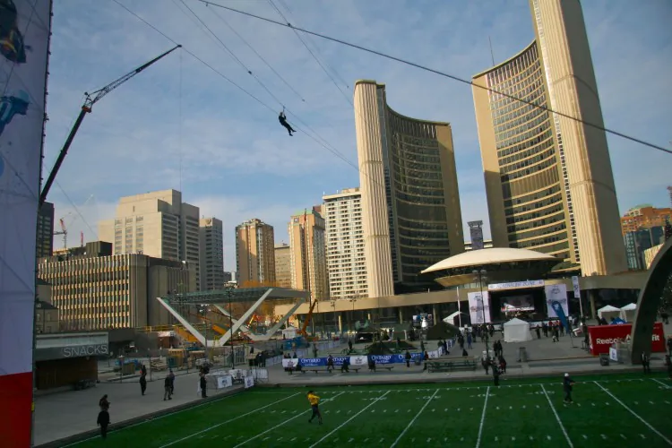 Visitors can ride the Toronto Sun Zipline over Nathan Phillips Square as part of the festivities in the lead-up to the 100th Grey Cup game on Sunday. (Kristina Skorbach/ The Epoch Times)