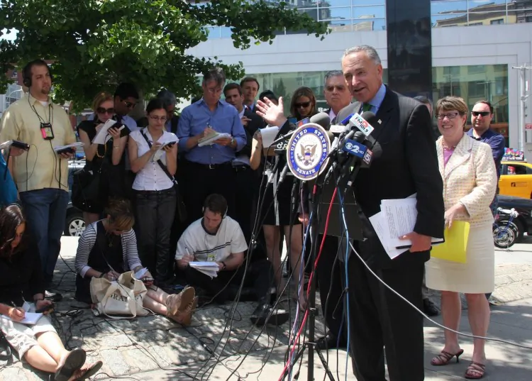 U.S. Sen. Charles Schumer speaks about inter-city bus safety from a Chinatown sidewalk Thursday. (Hannah Cai/The Epoch Times)