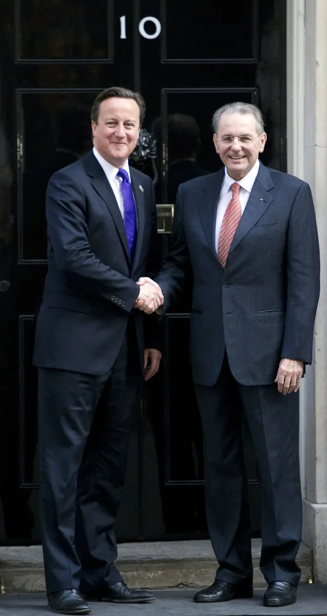 British Prime Minister David Cameron (L) shakes hands with International Olympic Committee (IOC) President Jacques Rogge (R) during a meeting in central London March 28. (Miguel Medina/AFP/Getty Images)